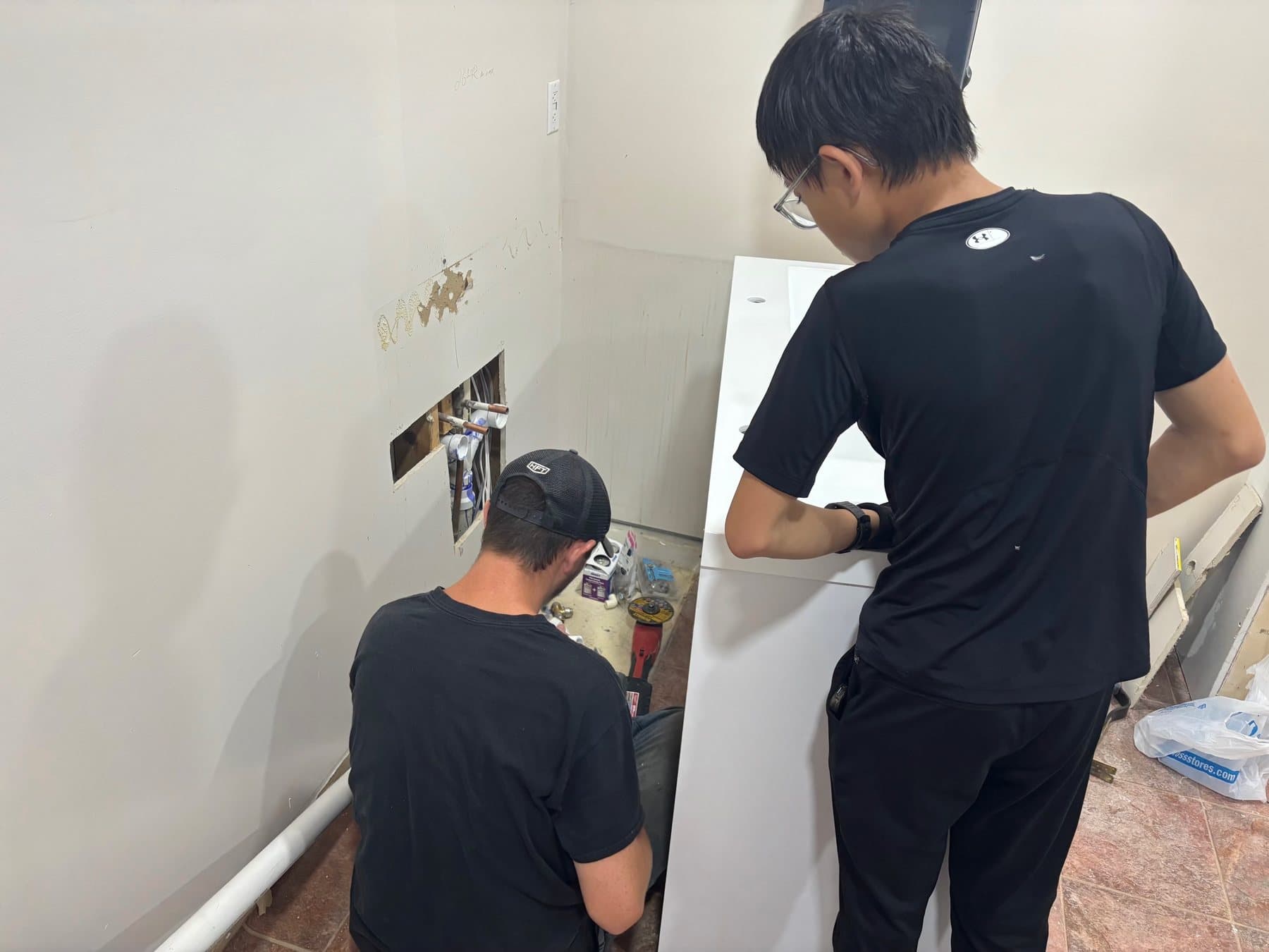 A young man patching a wall during the renovation