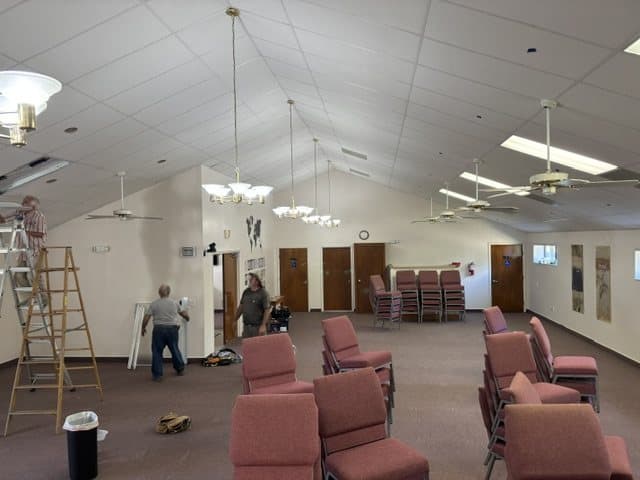 The sanctuary during the rebuild, chairs piled to one side and ladders against the walls
