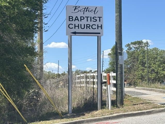 The new Bethel Baptist Church sign at the road, an arrow pointing to the church